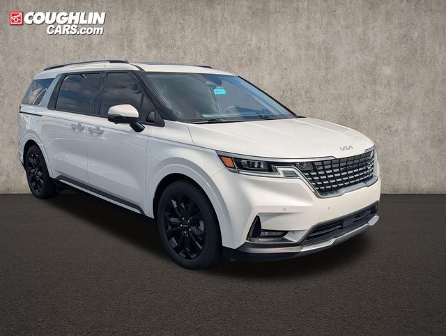 2024 Kia Carnival SX Prestige in Snow White Pearl — front three-quarter view