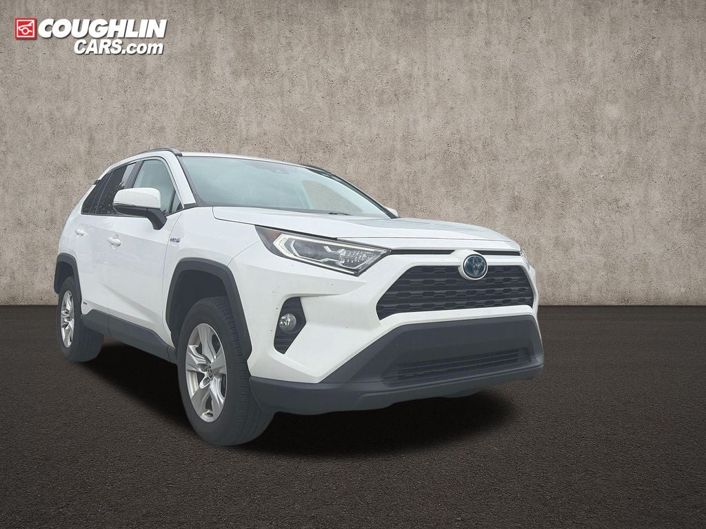 2021 Toyota RAV4 Hybrid XLE in Super White — front three-quarter view