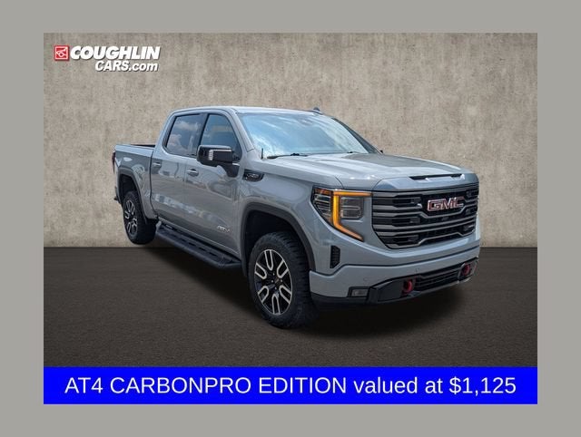 2024 GMC Sierra 1500 AT4 in Thunderstorm Gray — front three-quarter view